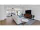 Comfortable living room with contemporary decor, wood floors, modern furniture, and a stylish entertainment center at 1432 S Keene Rd, Clearwater, FL 33756