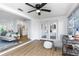 Open-concept space showcases seamless flow from living room to kitchen and sunroom, enhancing natural light and modern style at 1432 S Keene Rd, Clearwater, FL 33756
