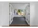 Screened-in porch showcasing French doors leading to Florida room, blending indoor/outdoor living with a view of fenced yard at 1432 S Keene Rd, Clearwater, FL 33756