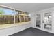 Screened-in porch featuring French doors to Florida room, providing an airy, outdoor space with a view of the backyard at 1432 S Keene Rd, Clearwater, FL 33756