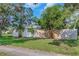 The side of the house shows a well-manicured lawn and a wooden fence, adding privacy and charm to the property at 1432 S Keene Rd, Clearwater, FL 33756