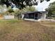 Spacious backyard with shed, mature trees, and screened-in porch at 1542 Sherwood St, Clearwater, FL 33755