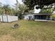 Large backyard featuring a fire pit, storage shed, mature trees, and screened in patio at 1542 Sherwood St, Clearwater, FL 33755