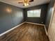 Comfortable bedroom with a ceiling fan and large window, freshly painted with new flooring at 1542 Sherwood St, Clearwater, FL 33755