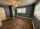 Cozy bedroom features a ceiling fan, closet, and natural light from windows. Freshly painted with new flooring at 1542 Sherwood St, Clearwater, FL 33755