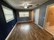 Bedroom with hardwood flooring, two windows, ceiling fan, and neutral paint at 1542 Sherwood St, Clearwater, FL 33755