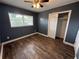 Comfortable bedroom with a closet and large window, freshly painted with new flooring at 1542 Sherwood St, Clearwater, FL 33755