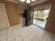 Bright eat-in kitchen with stainless steel refrigerator and sliding glass doors to patio at 1542 Sherwood St, Clearwater, FL 33755