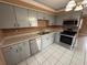 Cozy kitchen with stainless steel appliances, ample cabinet space, and light tile floors at 1542 Sherwood St, Clearwater, FL 33755
