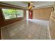 Inviting living room with tiled flooring, large window, and glass paneled front door at 1542 Sherwood St, Clearwater, FL 33755