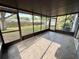 Large screened patio providing a comfortable outdoor living space with backyard access at 1542 Sherwood St, Clearwater, FL 33755