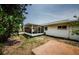 An exterior view of a home with a screened in porch with a concrete slab for entertaining at 1615 Stonehaven Way, Tarpon Springs, FL 34689
