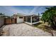 Home with a screened-in porch and stone pavers in the backyard at 1615 Stonehaven Way, Tarpon Springs, FL 34689