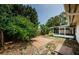 An exterior view of a home with a screened in porch and landscaped backyard at 1615 Stonehaven Way, Tarpon Springs, FL 34689