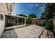 The backyard featuring a screened-in porch and gravel landscaping at 1615 Stonehaven Way, Tarpon Springs, FL 34689