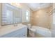 Bathroom with a stylish vanity, tiled shower/bath, and well-lit mirror at 1615 Stonehaven Way, Tarpon Springs, FL 34689