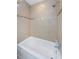 Shower/bath combo with bright tile, decorative mosaic border, and chrome fixtures at 1615 Stonehaven Way, Tarpon Springs, FL 34689