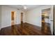 Bedroom with ceiling fan, wood floors, and connections to both the bathroom and kitchen at 1615 Stonehaven Way, Tarpon Springs, FL 34689