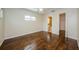 Bedroom with a ceiling fan, gleaming wood floors, and a connected bathroom at 1615 Stonehaven Way, Tarpon Springs, FL 34689