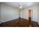 Bedroom with wood floors, ceiling fan and access to connected bathroom at 1615 Stonehaven Way, Tarpon Springs, FL 34689