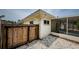 View of the rear of the home, highlighting the screened-in porch and wooden fence at 1615 Stonehaven Way, Tarpon Springs, FL 34689
