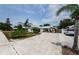Charming single-story home with a well-maintained lawn, mature palm trees, and a lengthy driveway at 1615 Stonehaven Way, Tarpon Springs, FL 34689