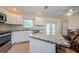 Kitchen with granite countertops, stainless appliances, and breakfast bar at 1615 Stonehaven Way, Tarpon Springs, FL 34689