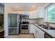 Kitchen with stainless steel appliances and granite countertops at 1615 Stonehaven Way, Tarpon Springs, FL 34689