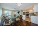 Open concept kitchen and dining area with stainless appliances and granite countertops at 1615 Stonehaven Way, Tarpon Springs, FL 34689