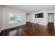 Bright living room with hardwood floors, large window, and neutral paint scheme at 1615 Stonehaven Way, Tarpon Springs, FL 34689
