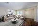 Cozy living room with modern decor, hardwood floors, and a large window at 1615 Stonehaven Way, Tarpon Springs, FL 34689