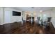 Hardwood floors create open-concept living space with a kitchen island and backyard access at 1615 Stonehaven Way, Tarpon Springs, FL 34689