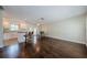 Spacious living space with hardwood floors, a ceiling fan, and access to the kitchen at 1615 Stonehaven Way, Tarpon Springs, FL 34689