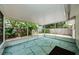 Spacious screened porch with geometric tile flooring, offering views of the private backyard at 1615 Stonehaven Way, Tarpon Springs, FL 34689