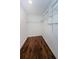 Spacious walk-in closet with dark floors and ample shelving for organized storage at 1615 Stonehaven Way, Tarpon Springs, FL 34689