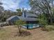 Aerial view of home with screened pool and surrounding mature trees, offering privacy and beauty at 17515 Drake Ct, Lutz, FL 33559
