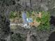 Overhead view of a private property with mature trees surrounding a brick home and a screened-in pool at 17515 Drake Ct, Lutz, FL 33559