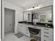 Elegant bathroom featuring a large vanity with black countertop and stylish fixtures at 17515 Drake Ct, Lutz, FL 33559