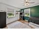 Bright bedroom featuring hard wood floors, two large windows, and a fresh two-tone paint scheme at 17515 Drake Ct, Lutz, FL 33559