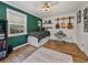 This bedroom features hard wood floors and guitars as wall art above a modern keyboard at 17515 Drake Ct, Lutz, FL 33559