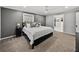 Bedroom features a bed with decorative pillows, soft carpet and a view into the walk in closet at 17515 Drake Ct, Lutz, FL 33559