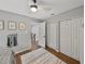 Bright bedroom with gray walls, ceiling fan, double closets, and view to the second floor landing at 17515 Drake Ct, Lutz, FL 33559