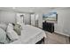 Nicely decorated bedroom offers a view to the walk-in closet and a large screen TV at 17515 Drake Ct, Lutz, FL 33559