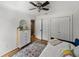 Bedroom featuring a dresser, closet, wood floors, a ceiling fan, and large area rug at 17515 Drake Ct, Lutz, FL 33559