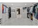 A gorgeous walk-in closet with marble floors leading to a soaking tub at 17515 Drake Ct, Lutz, FL 33559
