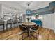 Charming dining area with a round wooden table, modern light fixture, and adjacent kitchen at 17515 Drake Ct, Lutz, FL 33559