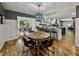 Open-concept dining area with hardwood floors, decorative lighting, and a view into the kitchen at 17515 Drake Ct, Lutz, FL 33559