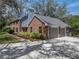 Charming multi-story brick home featuring a two-car garage and a well-maintained landscaped yard at 17515 Drake Ct, Lutz, FL 33559