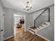 Entryway featuring hardwood floors, chandelier, stairway and view into the living room at 17515 Drake Ct, Lutz, FL 33559