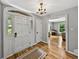 Bright foyer featuring hardwood floors, chandelier, and view into the living area at 17515 Drake Ct, Lutz, FL 33559